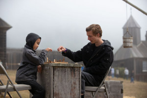 Two young men playing chess in the fog in the Fort Ross Compound