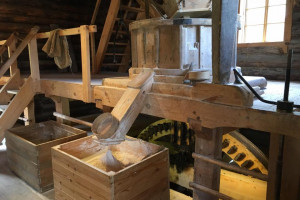 Millstones-above-and-chute-dispensing-flour