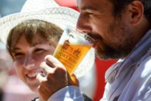 Happy people drinking a pint of beer during Fort Ross Festival